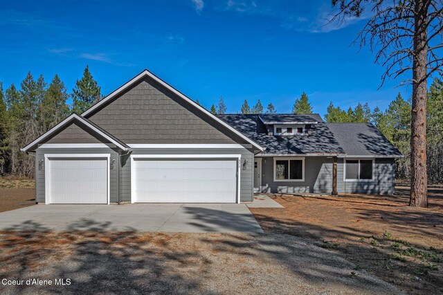 88 Happy Mdws, Athol, ID 83801 - view of front of house with driveway and an attached garage