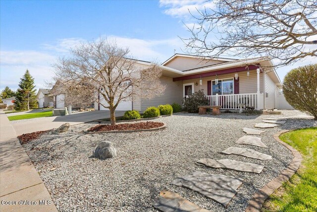 8514 W Grand Teton St, Rathdrum, ID 83858 - view of front of property featuring an attached garage, driveway, and a porch