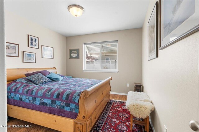 8514 W Grand Teton St, Rathdrum, ID 83858 - bedroom featuring wood finished floors and baseboards