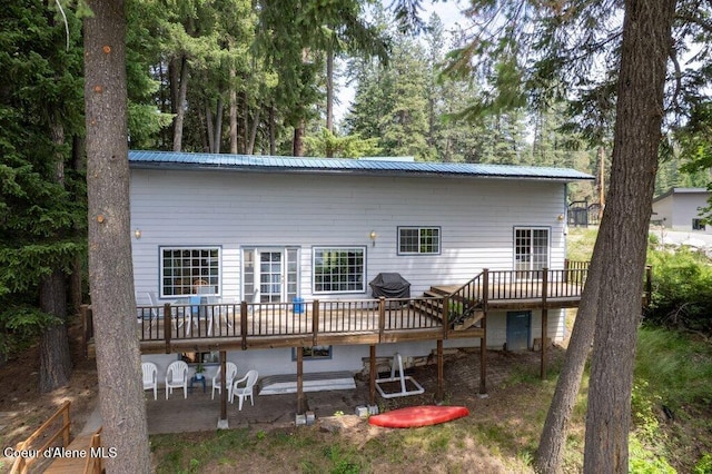 14314 N Waters Edge Ct, Hayden, ID 83835 - back of property featuring a wooden deck, a patio, and a metal roof