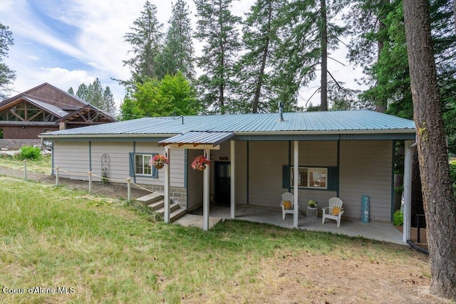 14314 N Waters Edge Ct, Hayden, ID 83835 - rear view of property with a metal roof and a patio