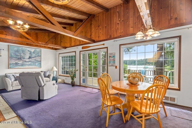 14314 N Waters Edge Ct, Hayden, ID 83835 - dining area with a chandelier, a wood ceiling with exposed beams, high vaulted ceiling, a water view, and carpet