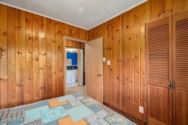 14314 N Waters Edge Ct, Hayden, ID 83835 - bedroom with wood walls, a closet, and crown molding