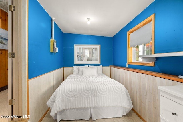 14314 N Waters Edge Ct, Hayden, ID 83835 - bedroom featuring a wainscoted wall and wood walls