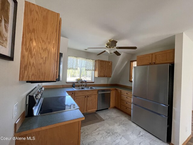 24731 N Wendler Loop, Rathdrum, ID 83858 - kitchen with stainless steel appliances, a ceiling fan, a sink, and brown cabinetry