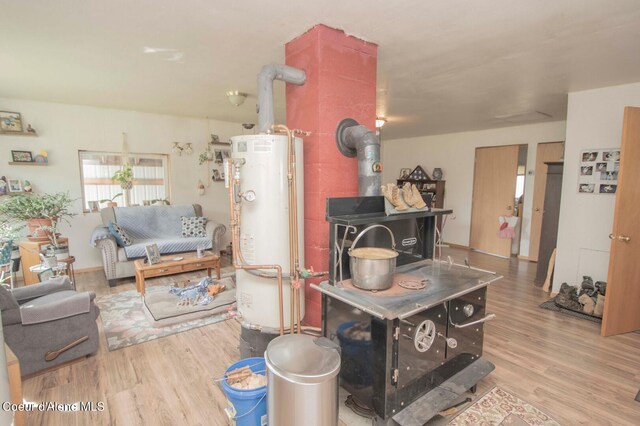 2884 Morris Rd, Naples, ID 83847 - living room with water heater, wood finished floors, and a wood stove