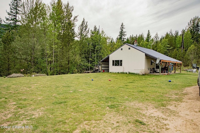 2884 Morris Rd, Naples, ID 83847 - view of yard with a forest view, an outdoor structure, and an outbuilding