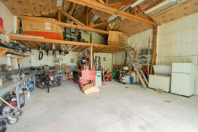 2884 Morris Rd, Naples, ID 83847 - garage with a workshop area and freestanding refrigerator