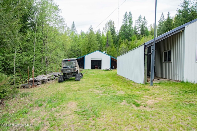 2884 Morris Rd, Naples, ID 83847 - view of yard with a forest view, an outbuilding, a detached garage, and a pole building