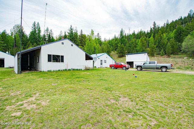 2884 Morris Rd, Naples, ID 83847 - view of yard with a forest view, an outbuilding, and driveway