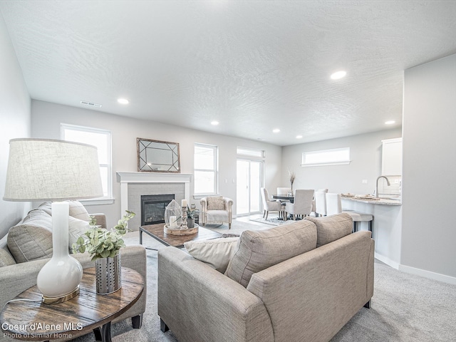 13748 N Apex Way, Hayden, ID 83835 - living room featuring a glass covered fireplace, visible vents, recessed lighting, and baseboards