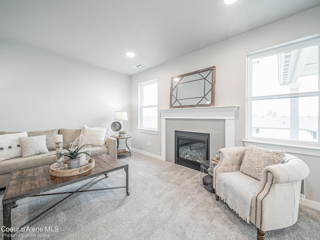 13748 N Apex Way, Hayden, ID 83835 - living area with baseboards, visible vents, carpet, and a brick fireplace
