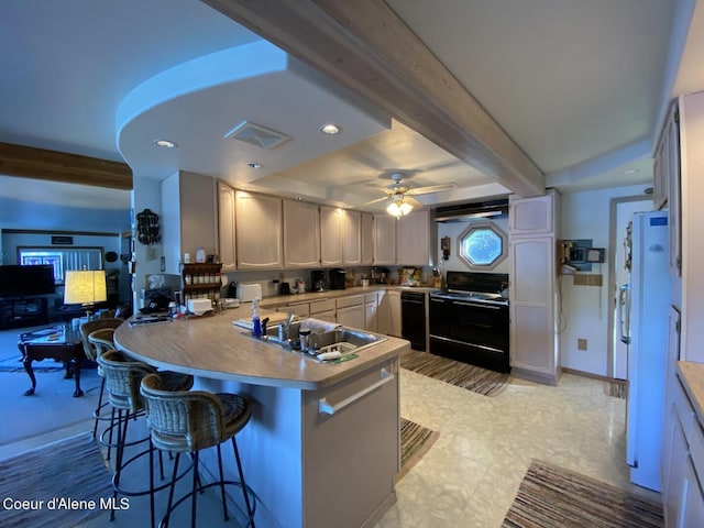 kitchen featuring black appliances, a peninsula, a sink, beam ceiling, and a ceiling fan