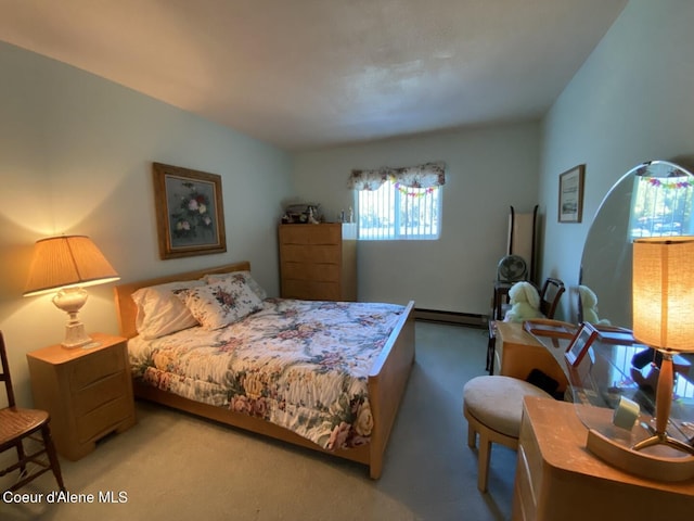 bedroom featuring light carpet and baseboard heating