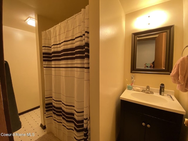 bathroom featuring tile patterned floors, vanity, and a shower with shower curtain