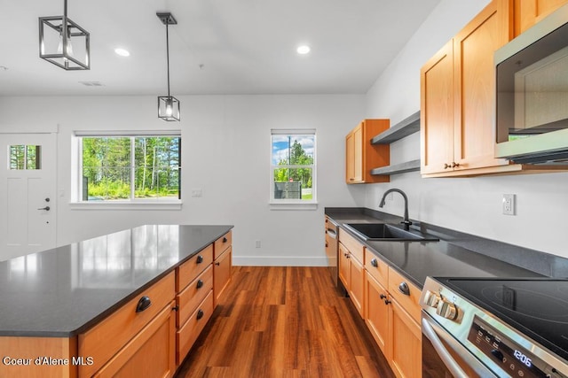 50 Carnelian Ave Unit 203, Ponderay, ID 83852 - kitchen featuring open shelves, dark wood-style flooring, baseboards, a sink, and appliances with stainless steel finishes