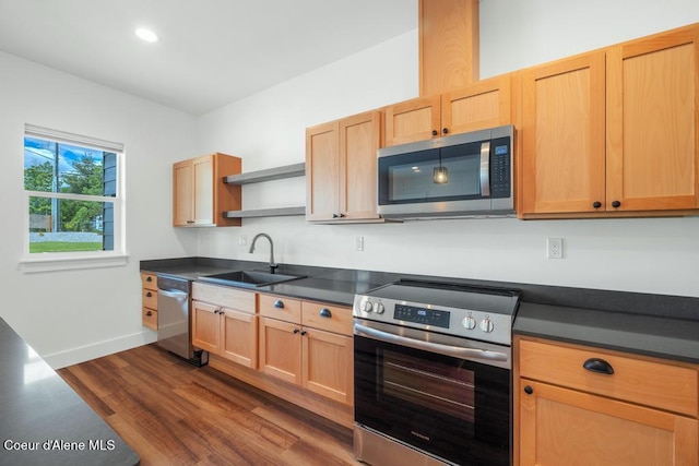 50 Carnelian Ave Unit 203, Ponderay, ID 83852 - kitchen with appliances with stainless steel finishes, dark countertops, open shelves, a sink, and dark wood-type flooring