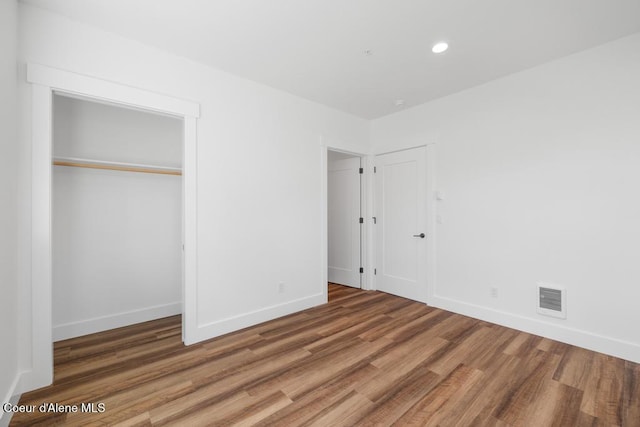 50 Carnelian Ave Unit 203, Ponderay, ID 83852 - unfurnished bedroom with visible vents, recessed lighting, baseboards, and wood finished floors