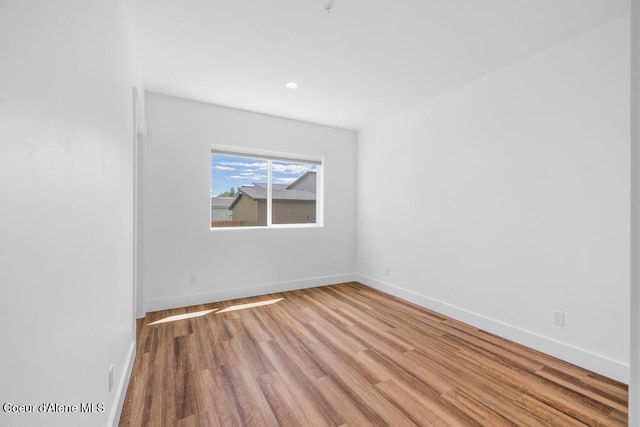 50 Carnelian Ave Unit 203, Ponderay, ID 83852 - spare room with baseboards, recessed lighting, and wood finished floors