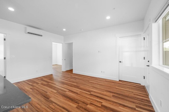 50 Carnelian Ave Unit 203, Ponderay, ID 83852 - spare room with recessed lighting, baseboards, wood finished floors, and a wall mounted air conditioner