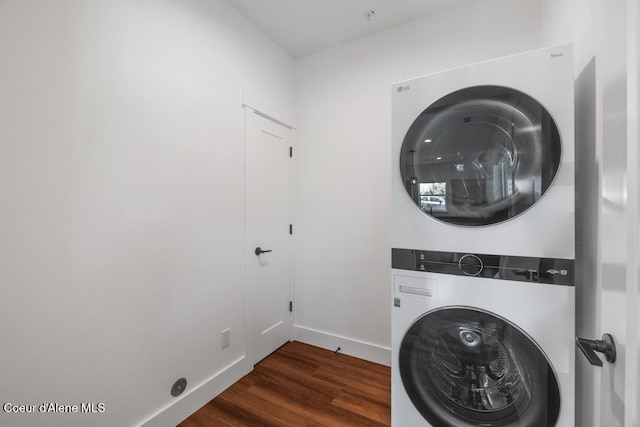50 Carnelian Ave Unit 203, Ponderay, ID 83852 - laundry room featuring baseboards, laundry area, stacked washer and dryer, and wood finished floors