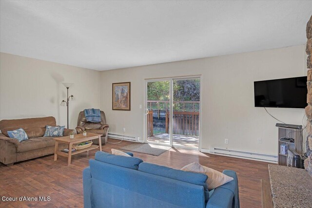 living room with a baseboard radiator, wood finished floors, and baseboards