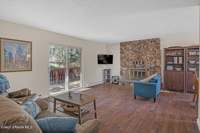 living room featuring a stone fireplace, baseboard heating, and wood finished floors
