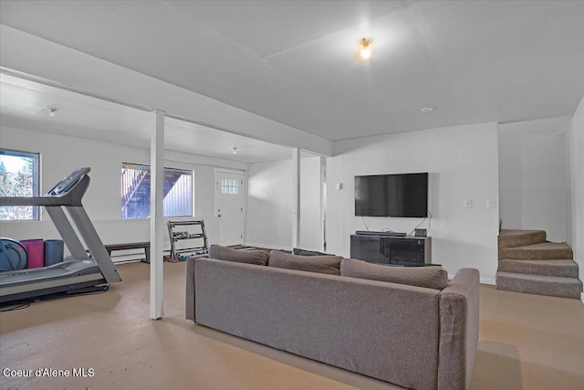 living area featuring a wealth of natural light and stairway