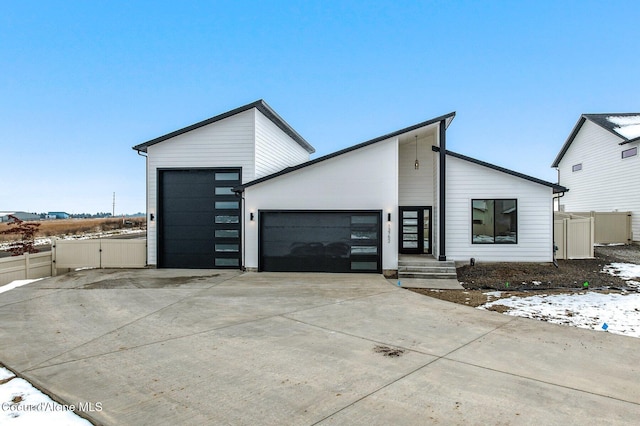 NNN Rocky Rd, Rathdrum, ID 83858 - contemporary house with concrete driveway, an attached garage, and fence
