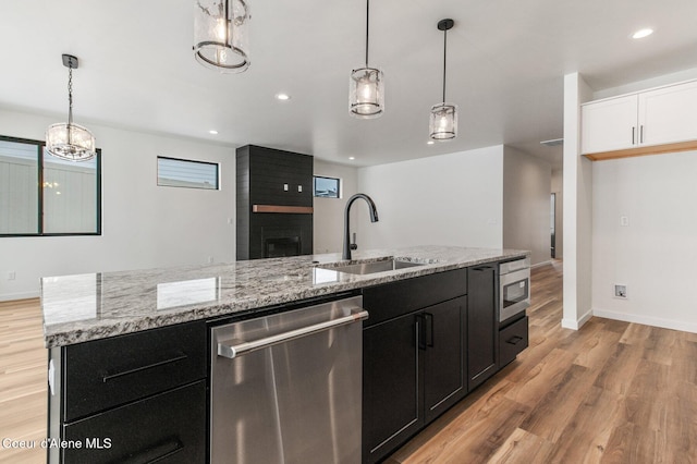 NNN Rocky Rd, Rathdrum, ID 83858 - kitchen with dishwasher, dark cabinets, a sink, and light wood finished floors