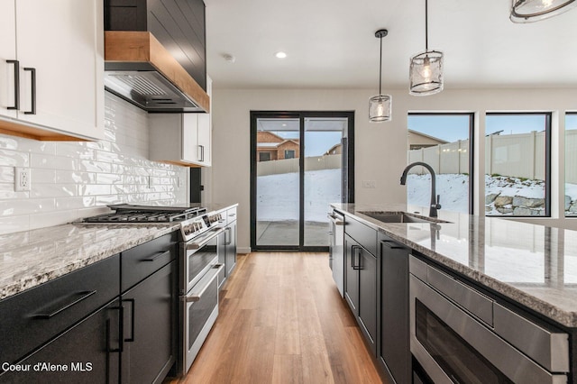NNN Rocky Rd, Rathdrum, ID 83858 - kitchen with premium range hood, a wealth of natural light, appliances with stainless steel finishes, and a sink