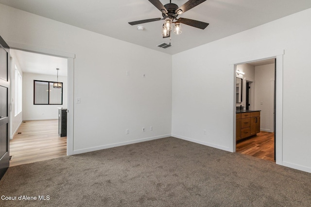 NNN Rocky Rd, Rathdrum, ID 83858 - unfurnished bedroom with an inviting chandelier, visible vents, ensuite bath, baseboards, and carpet flooring