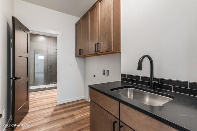 NNN Rocky Rd, Rathdrum, ID 83858 - kitchen featuring dark countertops, light wood-style flooring, baseboards, and a sink