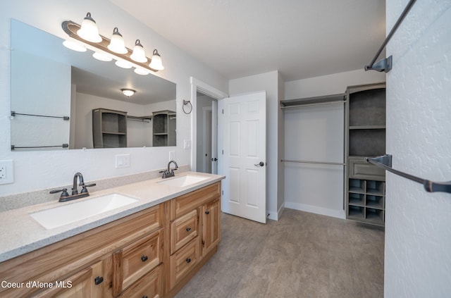 full bathroom with wood finished floors, a sink, and double vanity