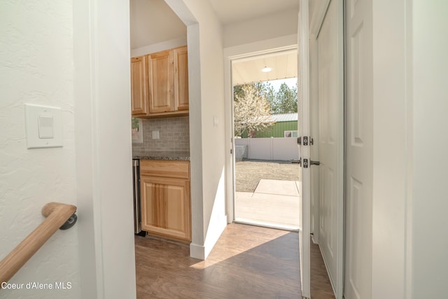 entryway with a textured wall and wood finished floors