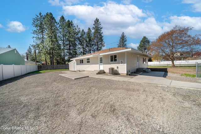 rear view of house featuring fence, a patio area, entry steps, and a storage shed