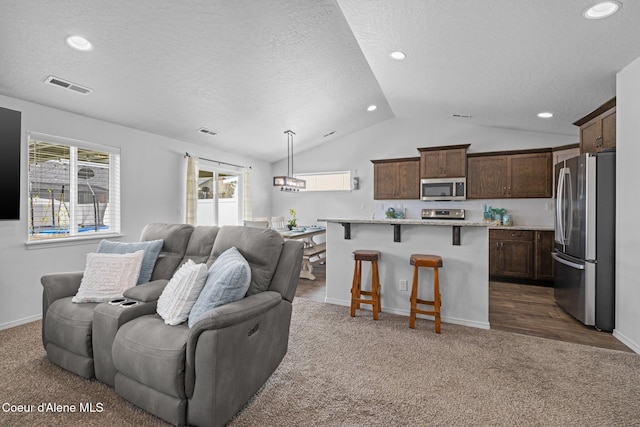 living room featuring a textured ceiling, visible vents, vaulted ceiling, recessed lighting, and dark carpet