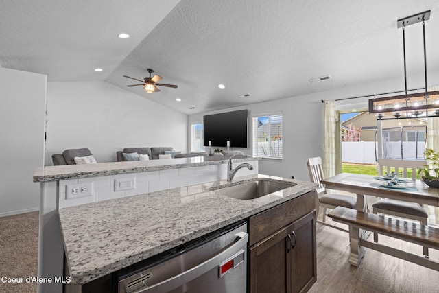 kitchen featuring a sink, an island with sink, open floor plan, stainless steel dishwasher, and visible vents