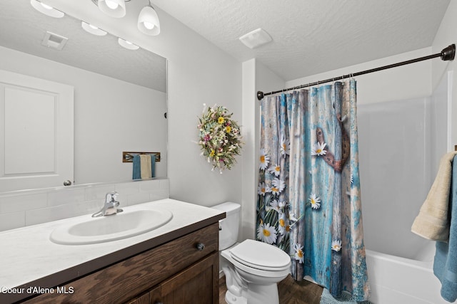 bathroom featuring a textured ceiling, visible vents, tasteful backsplash, vanity, and toilet