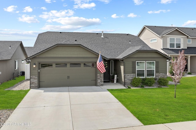 craftsman inspired home featuring a garage, a front lawn, stone siding, roof with shingles, and concrete driveway