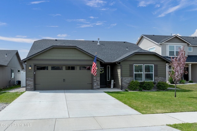 view of front of home featuring a front lawn, concrete driveway, an attached garage, a shingled roof, and stone siding