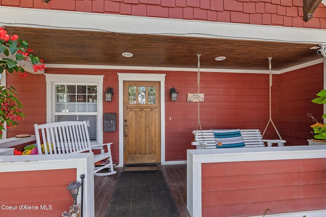view of exterior entry with a porch