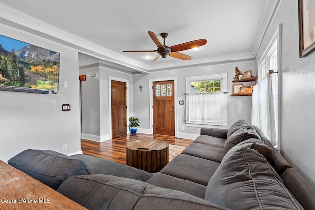 living area with crown molding, baseboards, ceiling fan, and wood finished floors