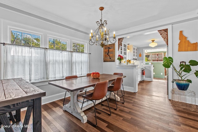 dining room with crown molding, a chandelier, plenty of natural light, and hardwood / wood-style flooring