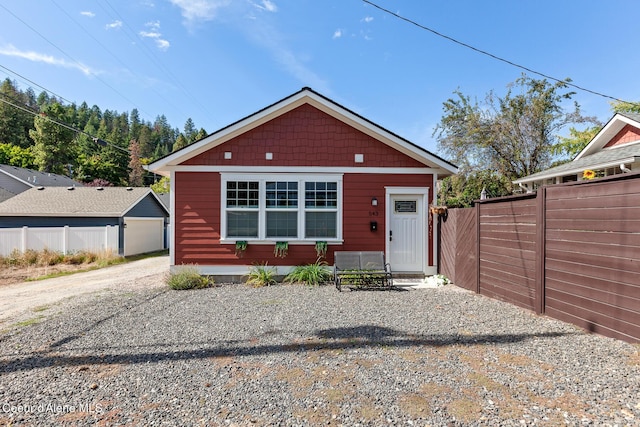 bungalow-style home featuring fence