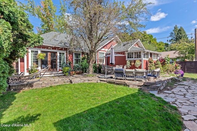 back of property featuring a lawn, a patio, and fence