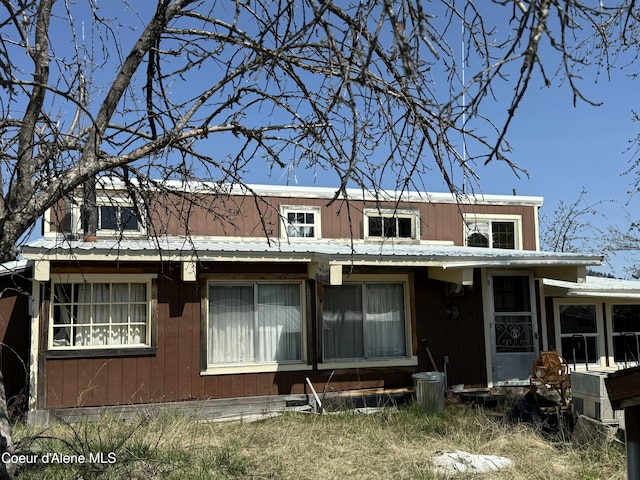 back of property featuring metal roof