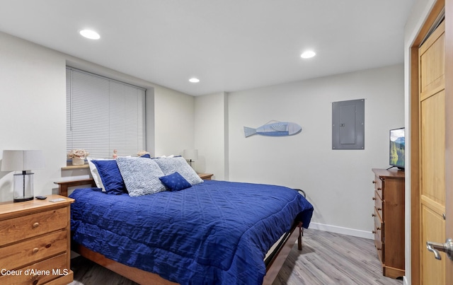 720 N 3rd Ave Unit 12, Sandpoint, ID 83864 - bedroom featuring electric panel, light wood-style flooring, baseboards, and recessed lighting