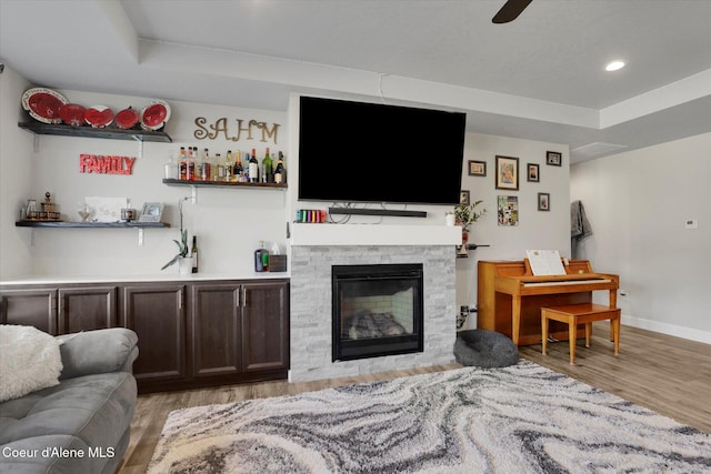 2982 N Bygone Way, Post Falls, ID 83854 - living area featuring a raised ceiling, baseboards, indoor bar, and light wood finished floors