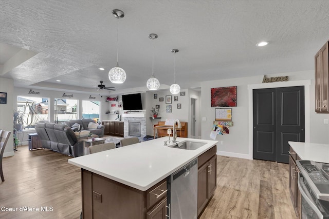2982 N Bygone Way, Post Falls, ID 83854 - kitchen featuring a sink, appliances with stainless steel finishes, a textured ceiling, and light countertops